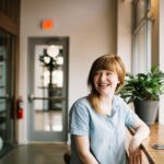woman sitting in front of brown wooden table
